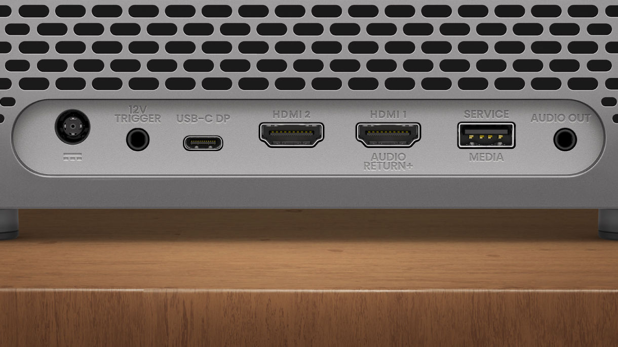 Close-up of BenQ TK705i home entertainment projector ports including HDMI, USB-C, USB-A, audio out, and Bluetooth